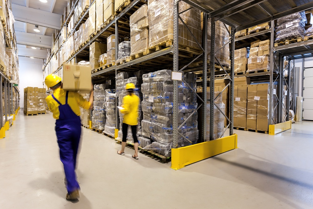 Warehouse workers storing up home equipments.